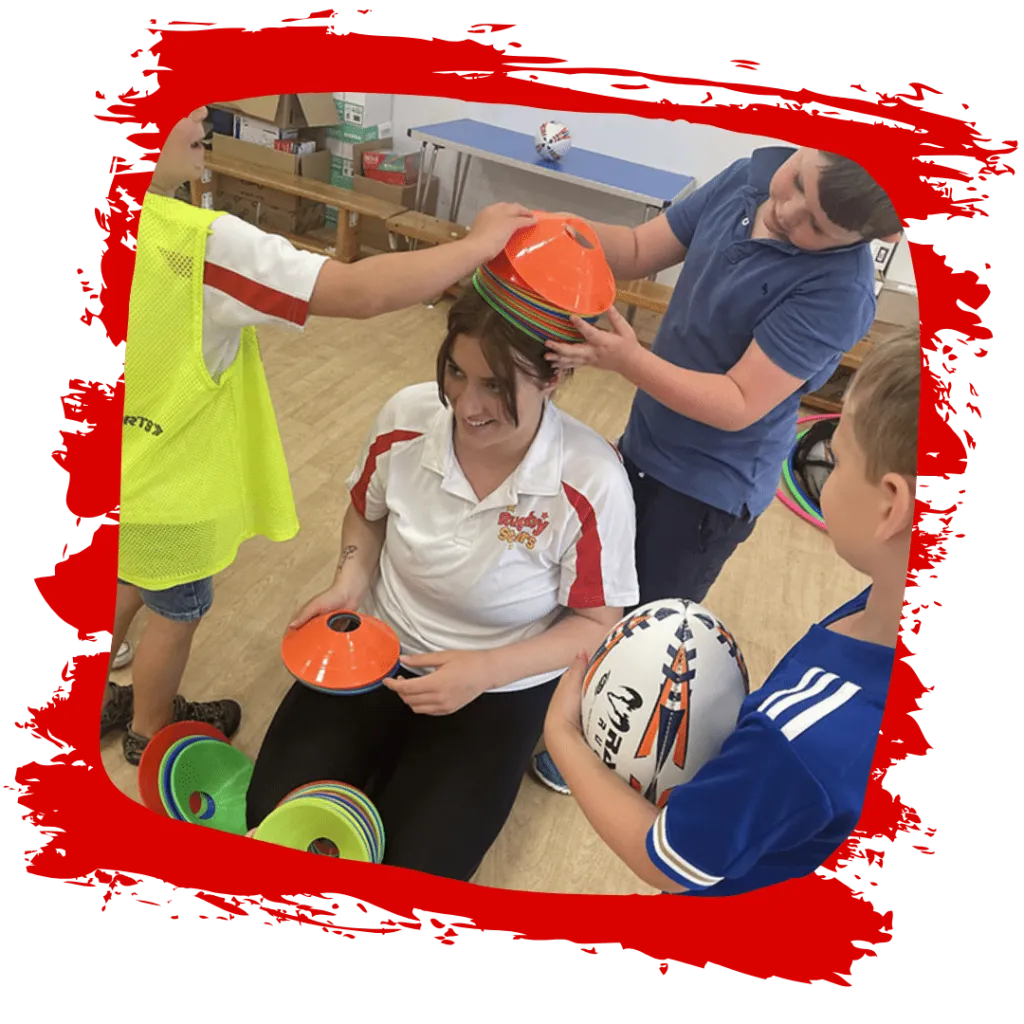 A coach leading children in a fun game during a Rugby Stars session in Kibworth and Market Harborough